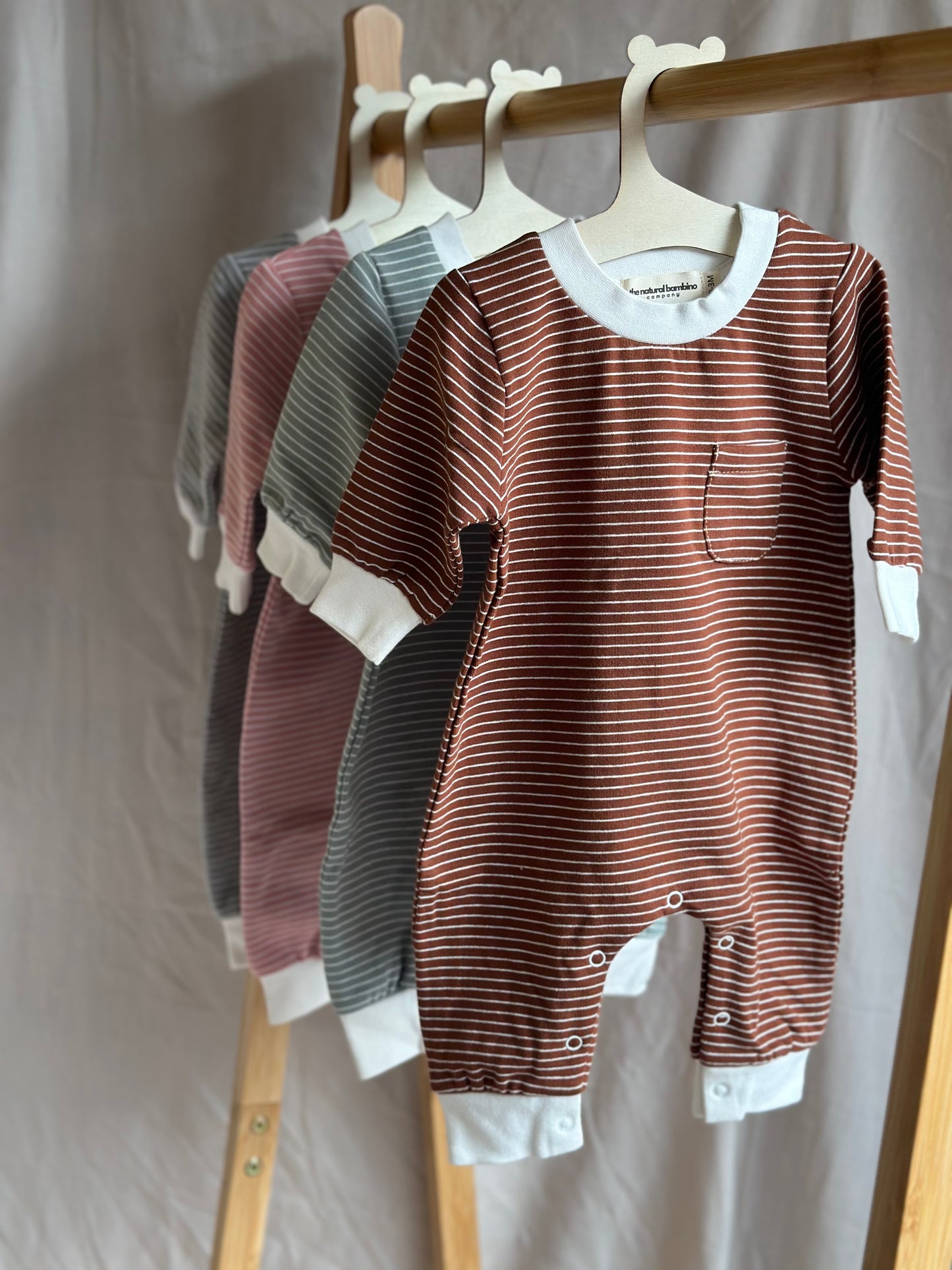 Set of 4 striped sleepsuits on wooden hangers