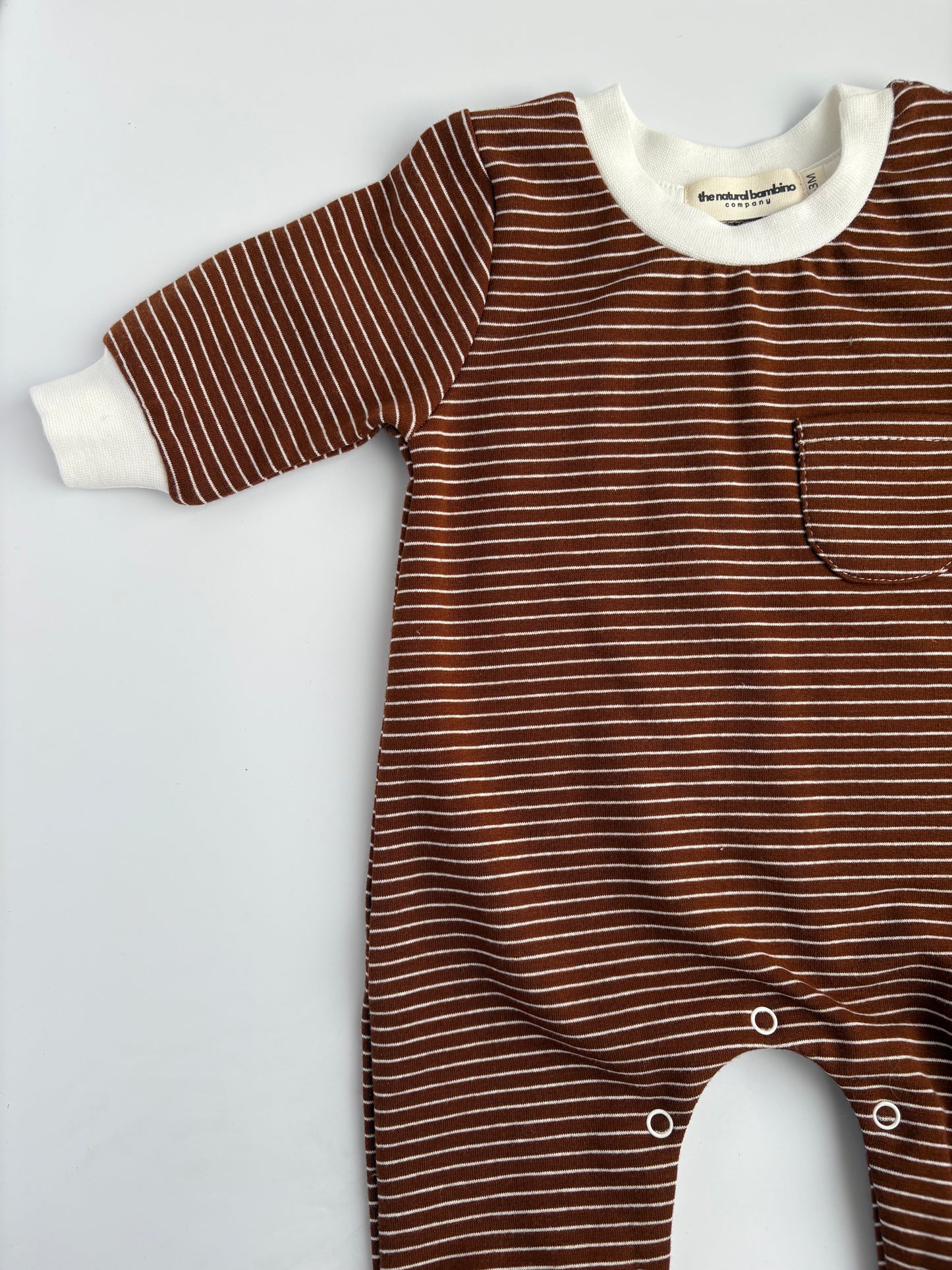 brown striped sleepsuit laid on a white background