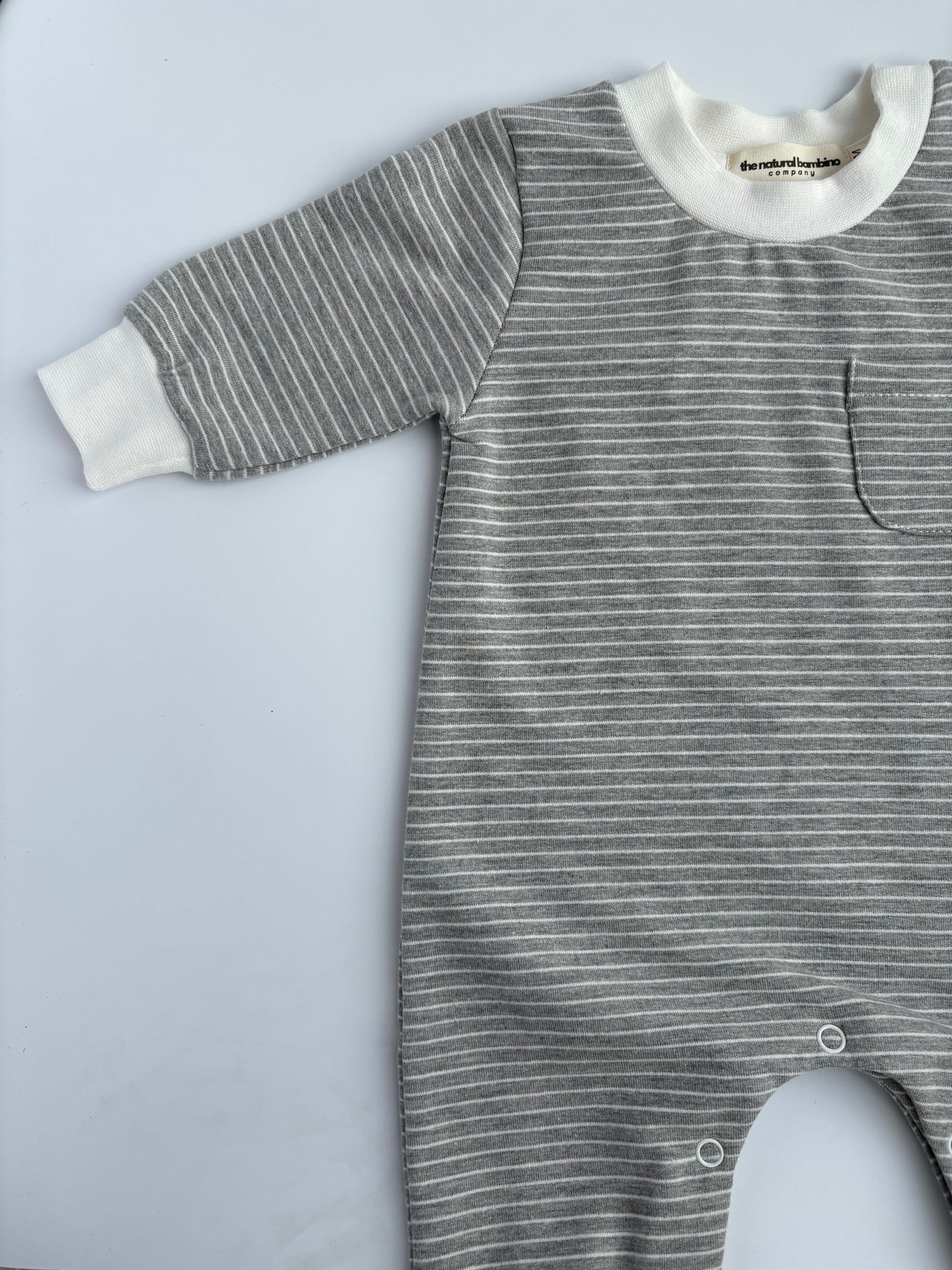 grey striped sleepsuit laid on a white background