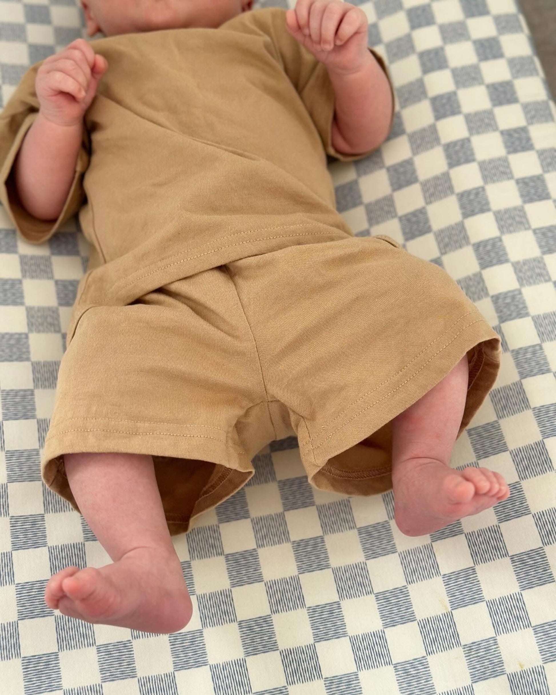 Soft organic cotton baby t-shirt and shorts set modelled on a 1 month old baby 