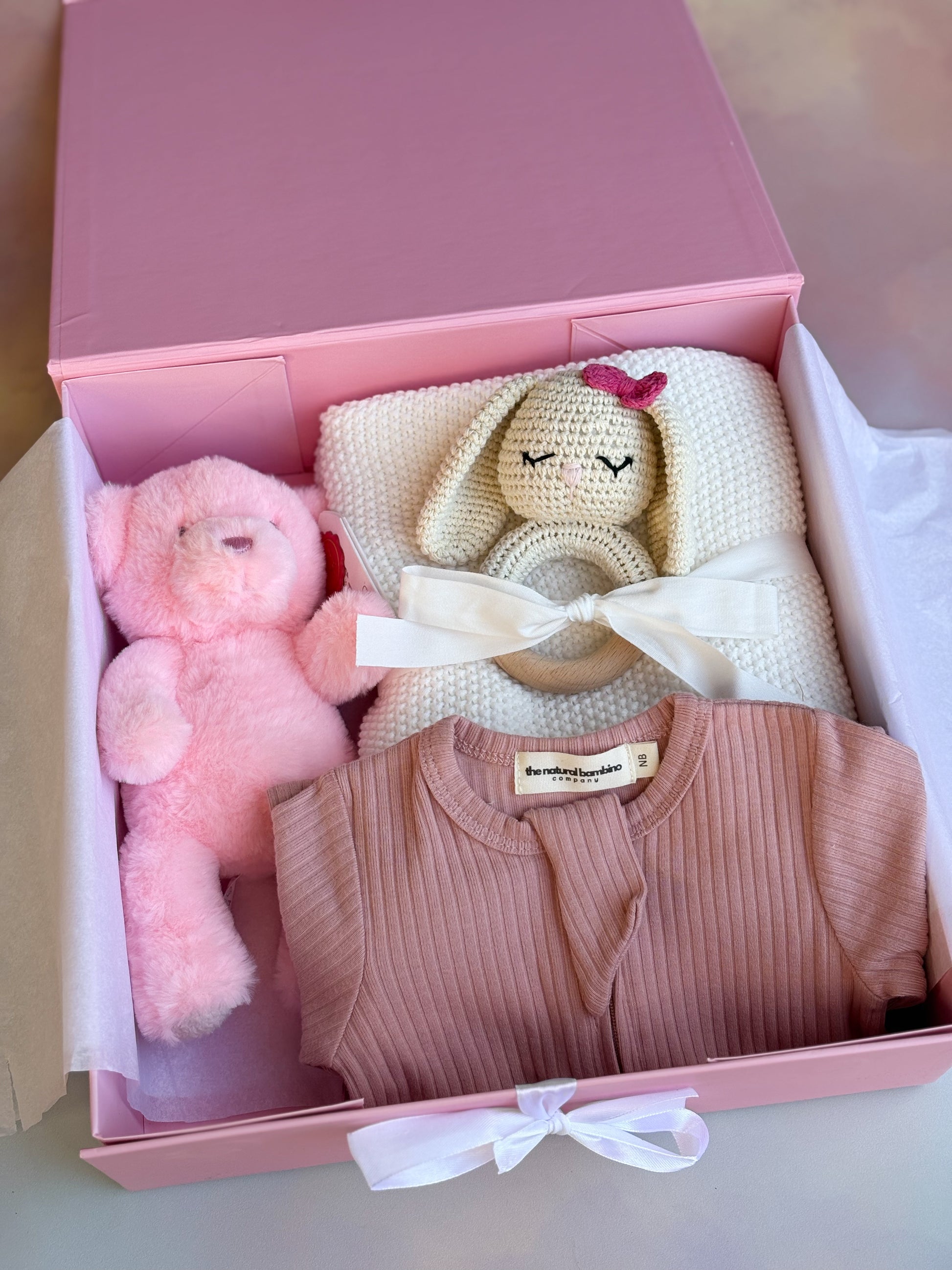 pink gift box with 4 cute baby items 