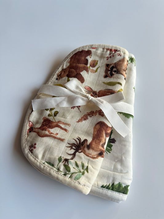Set of 2 woodland theme muslin burp cloths folded together and wrapped in a bow