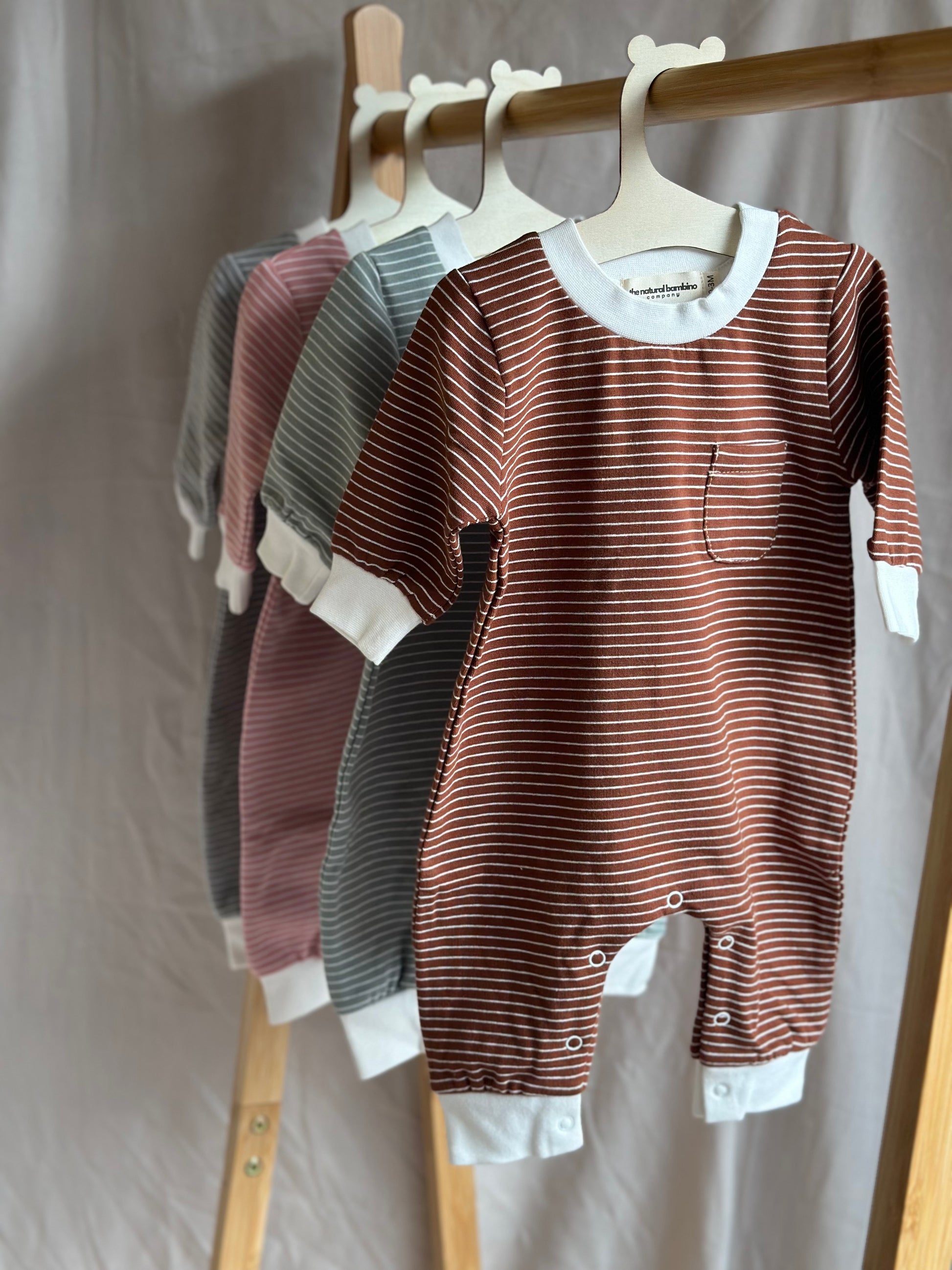 Set of 4 striped sleepsuits on wooden hangers